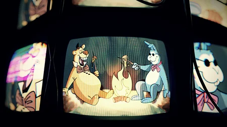 Vintage TV screens showing cartoon characters from Junior's restaurant